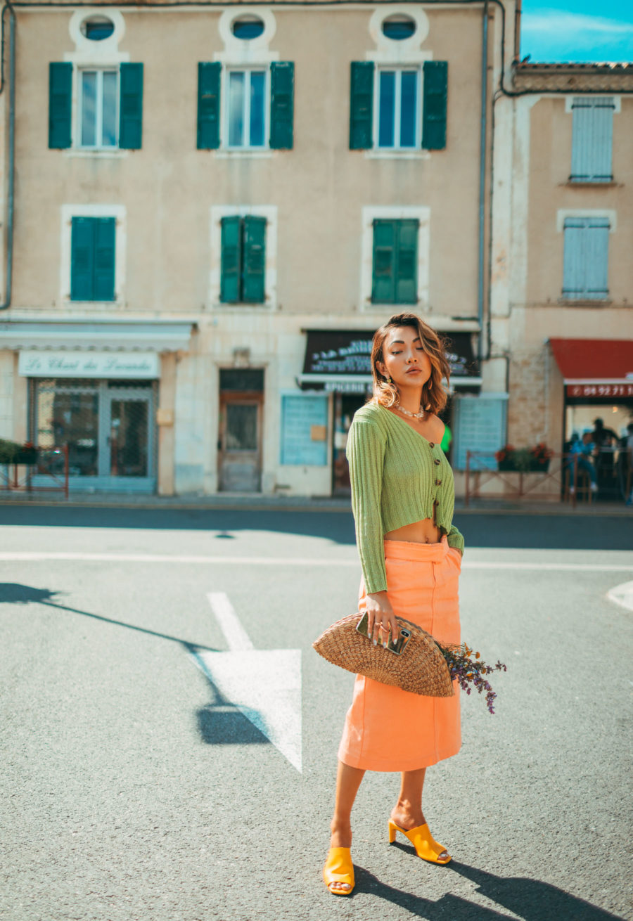 spring 2021 fashion trends - green knit cardigan, yellow mules, orange skirt, color block outfit, fashion in provence // Jessica Wang - Notjessfashion.com