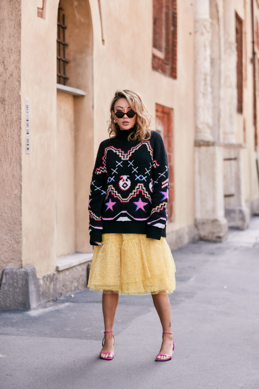fashion blogger jessica wang shares thanksgiving day outfit ideas and wears a tulle skirt with a large graphic sweater // Notjessfashion.com