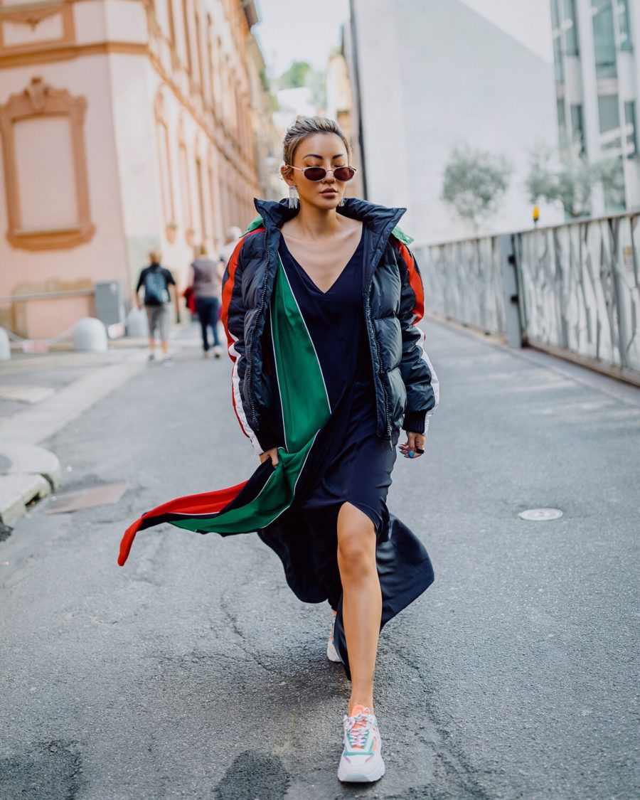 Jessica Wang wearing a puffer coat with a silk v neck dress and sneakers while sharing her favorite fall and winter coats // Jessica Wang - Notjessfashion.com