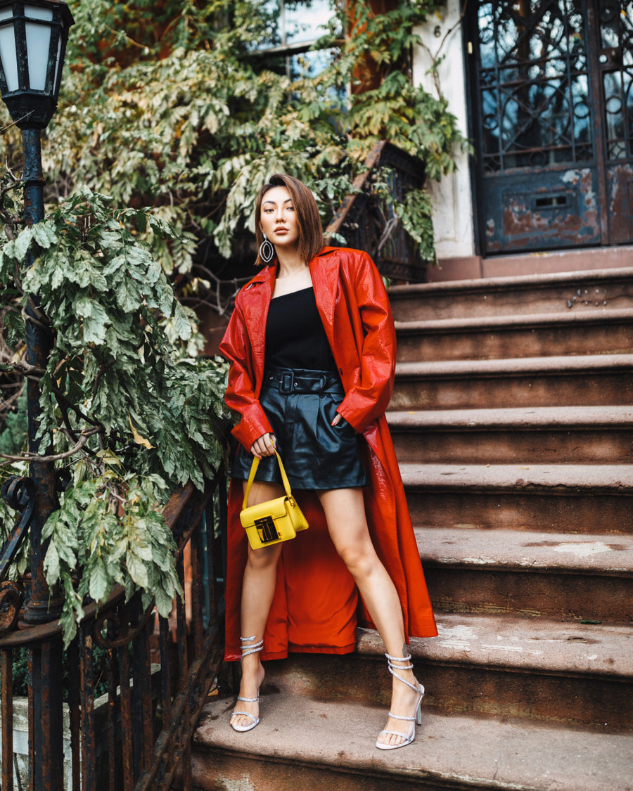 Jessica Wang wearing a summer to fall outfit featuring a red jacket, a black top, and leather shorts // Jessica Wang - Notjessfashion.com