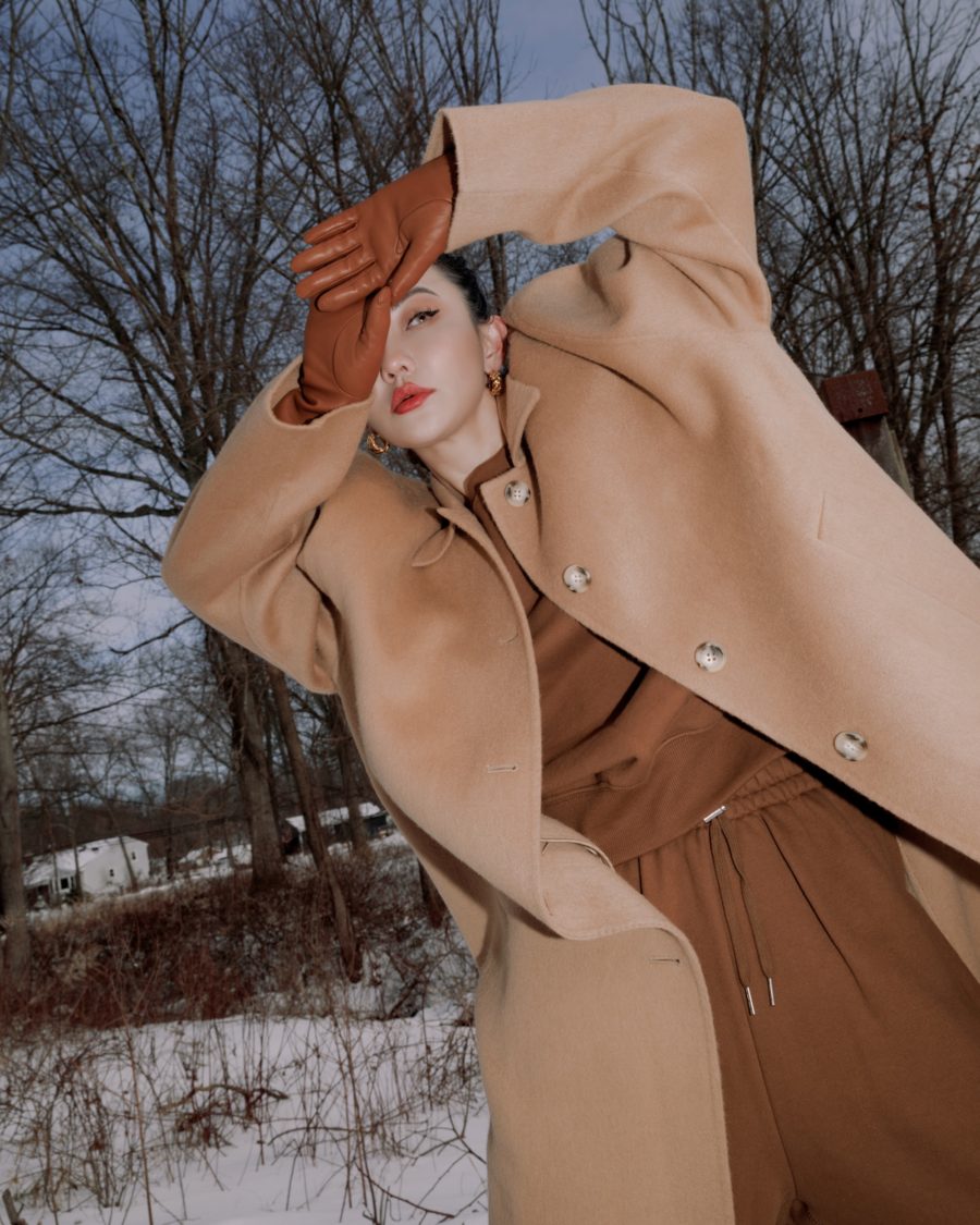 Jessica Wang wearing a camel coat with a brown sweater and leather gloves while sharing tips on how to layer for winter // Jessica Wang - Notjessfashion.com