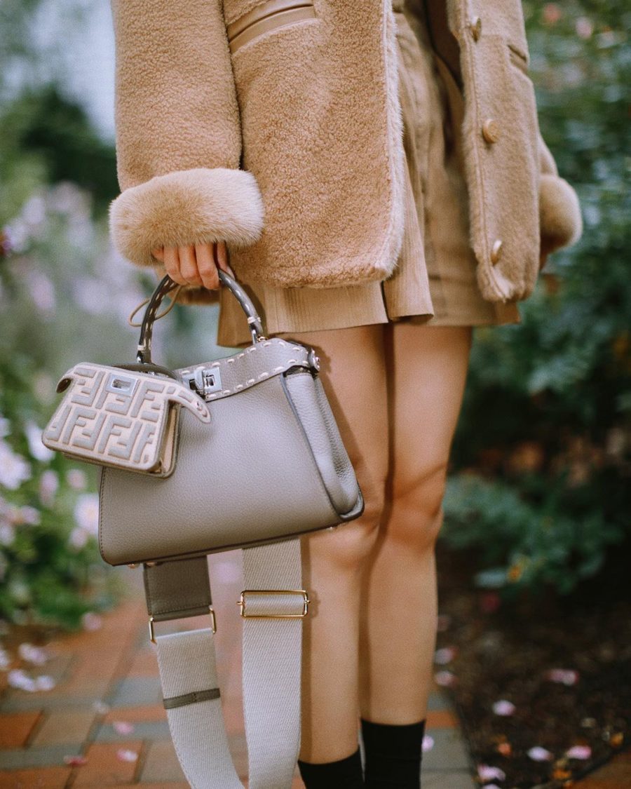 Jessica Wang wearing a neutral outfit featuring faux fur lined coat with corduroy shorts and a tan turtleneck shirt and carrying a fendi bag // Jessica Wang - Notjessfashion.com