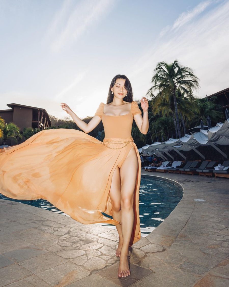 Jessica Wang wearing a trendy vacation outfit featuring a delos one piece swimsuit and hera chiffon skirt // Jessica Wang - Notjessfashion.com